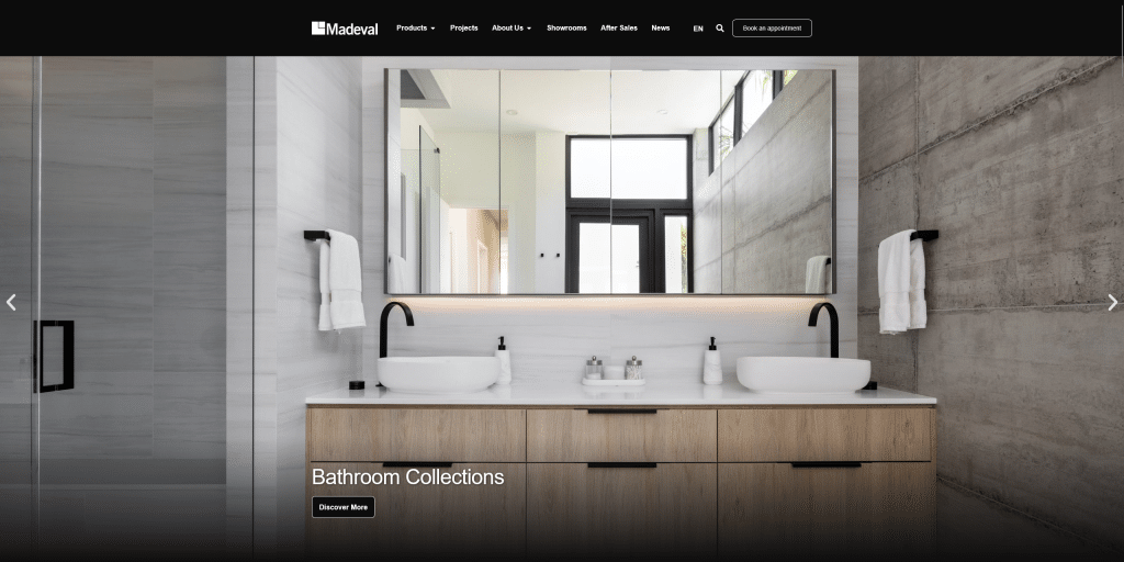 Modern bathroom with double sinks, wood cabinetry, and large mirrors.